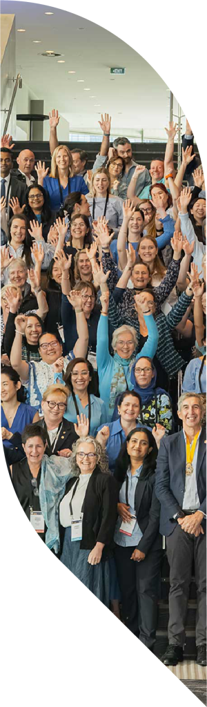 A large group of people with their hands raised