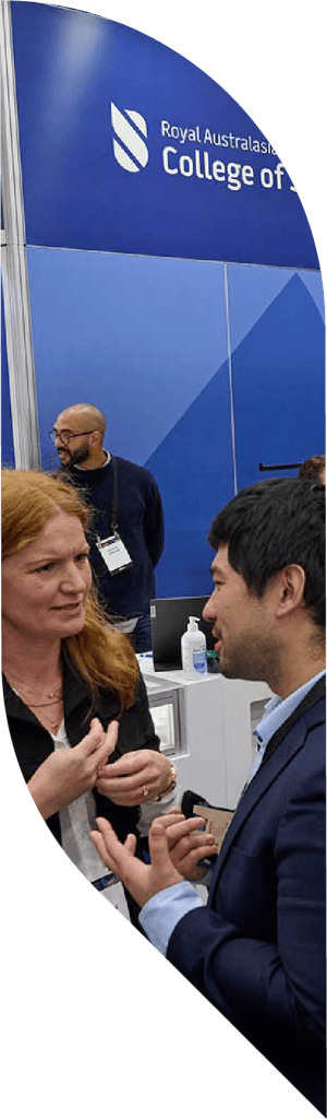 A man and woman in deep conversating in front of an exhibition booth